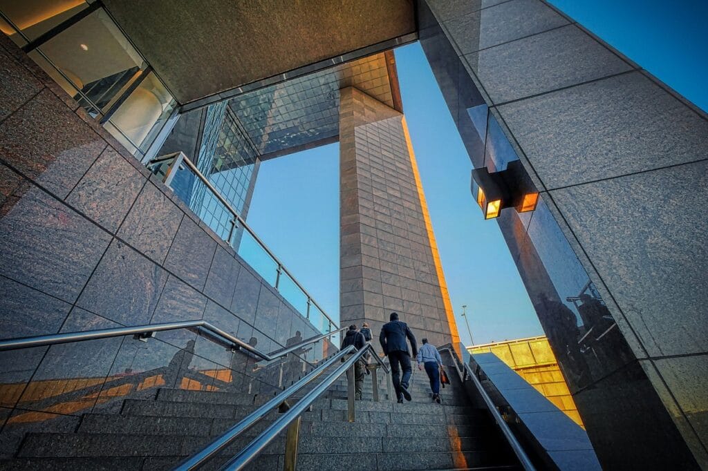 a group of people climbing up career transition stairs
