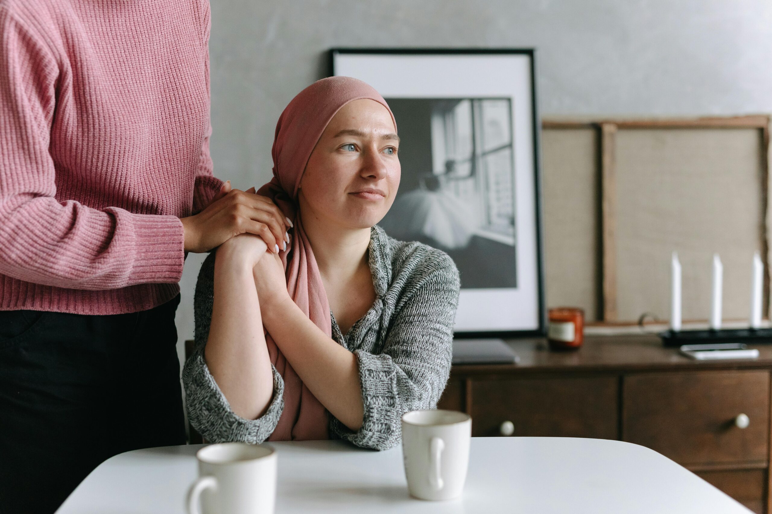 A person holding hands with a woman, building resilience, while sitting at a table