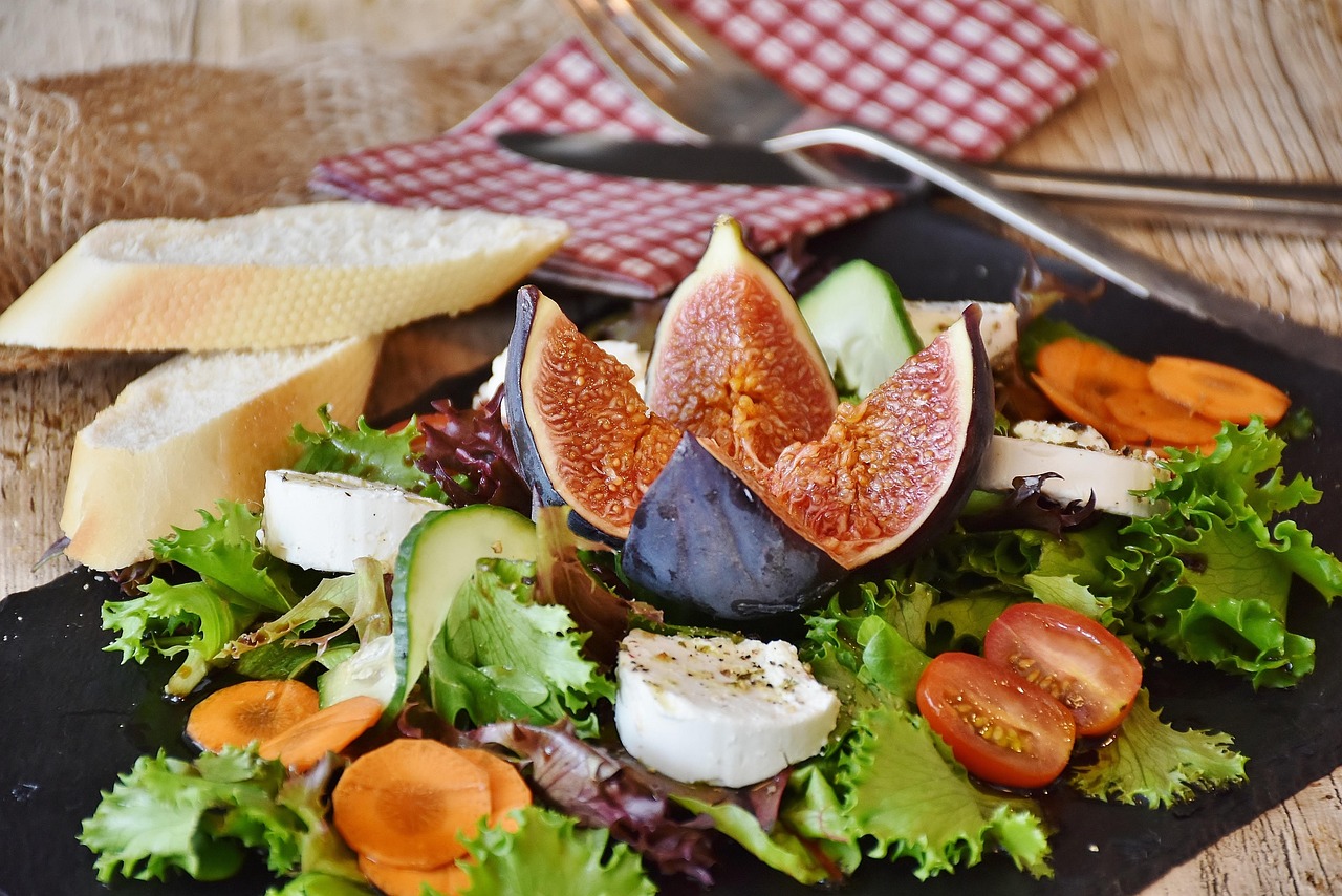 Plate filled with different fruits and lettuce. healthy food is important for a stable blood sugar