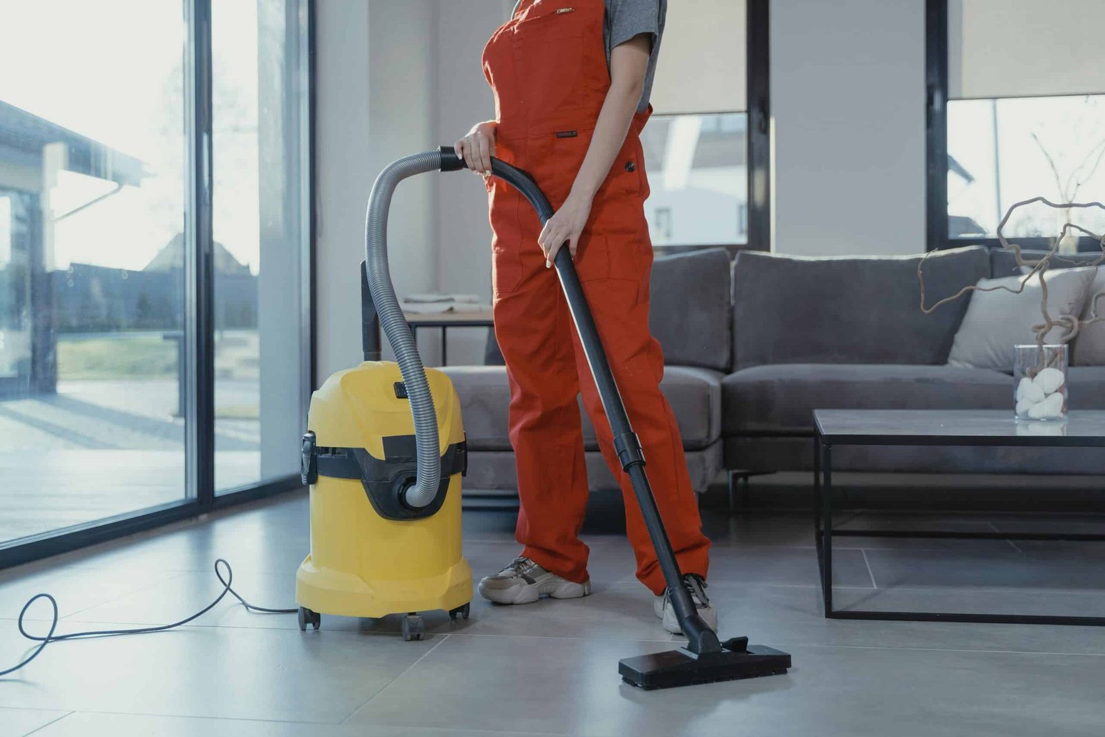 Person vacuuming the floor during spring cleaning