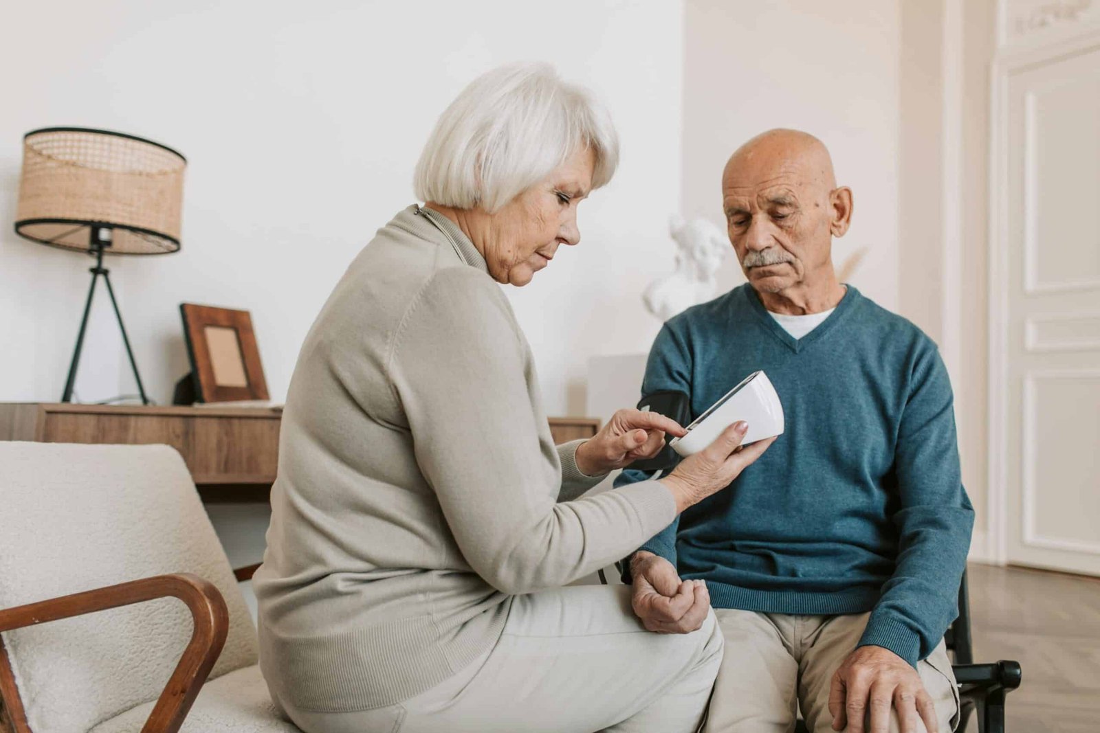 Woman, Caring for someone with dementia, sitting across a man