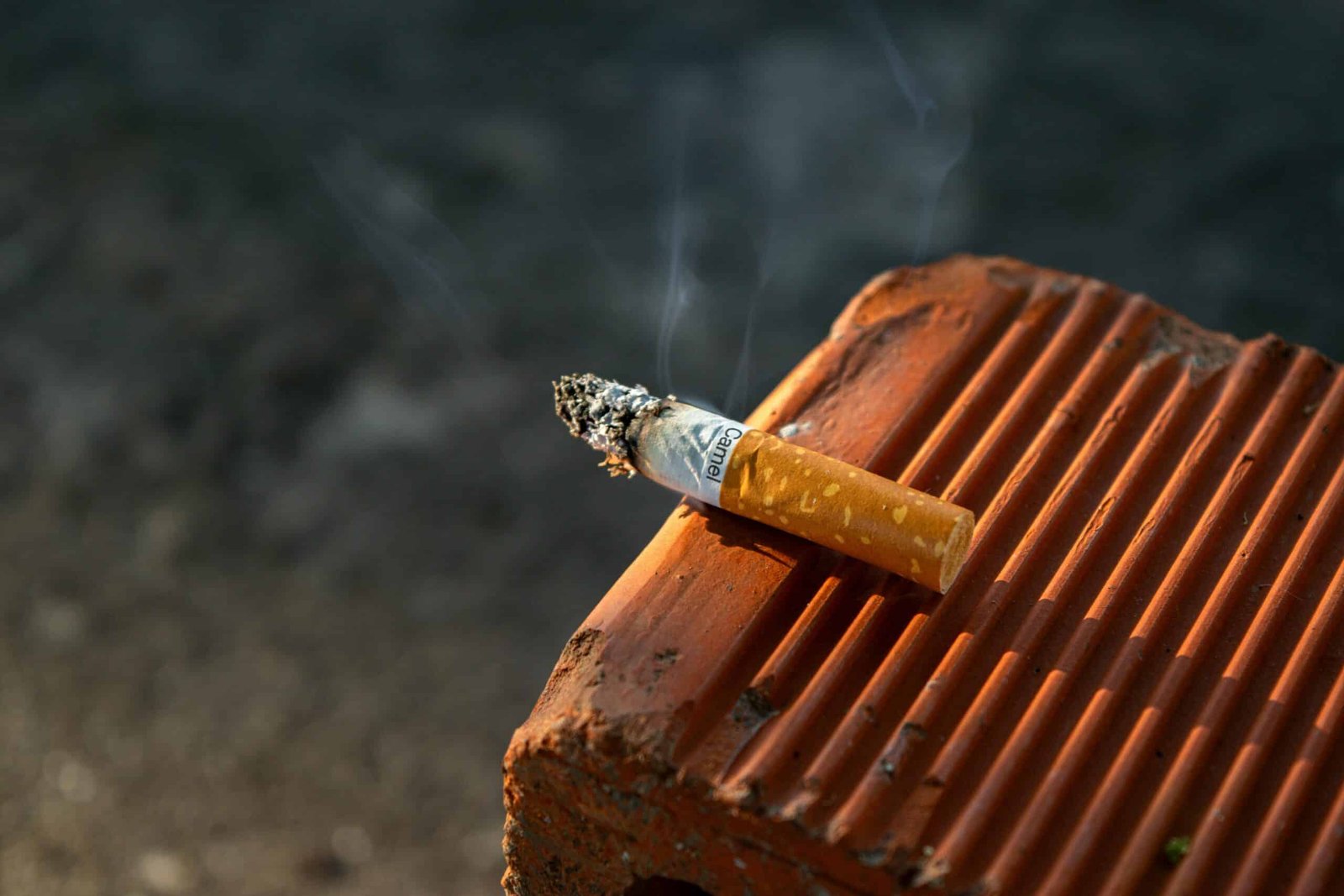 Cigarette on a bench. Breaking bad habits can be really tough.