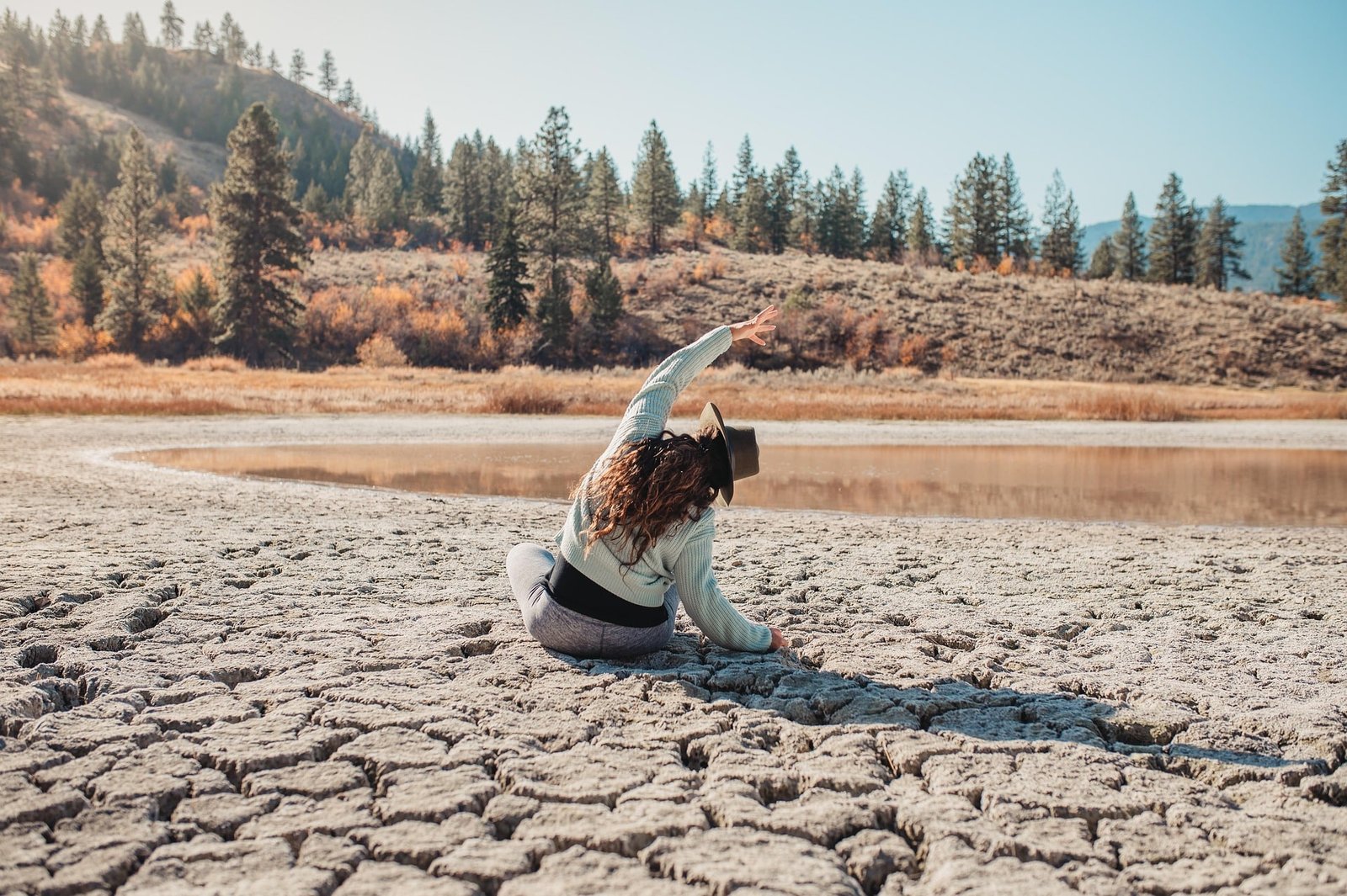 Woman practicing mindfulness next to a lake